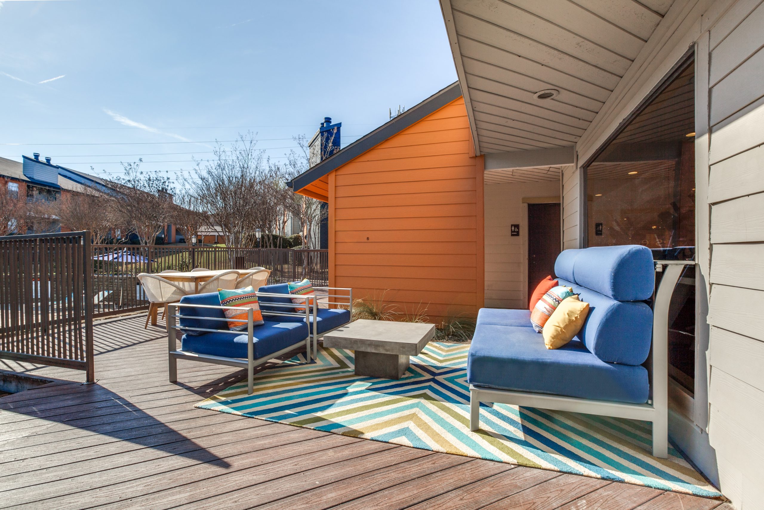 a deck with blue and orange furniture and a blue and orange rug at The Preslee