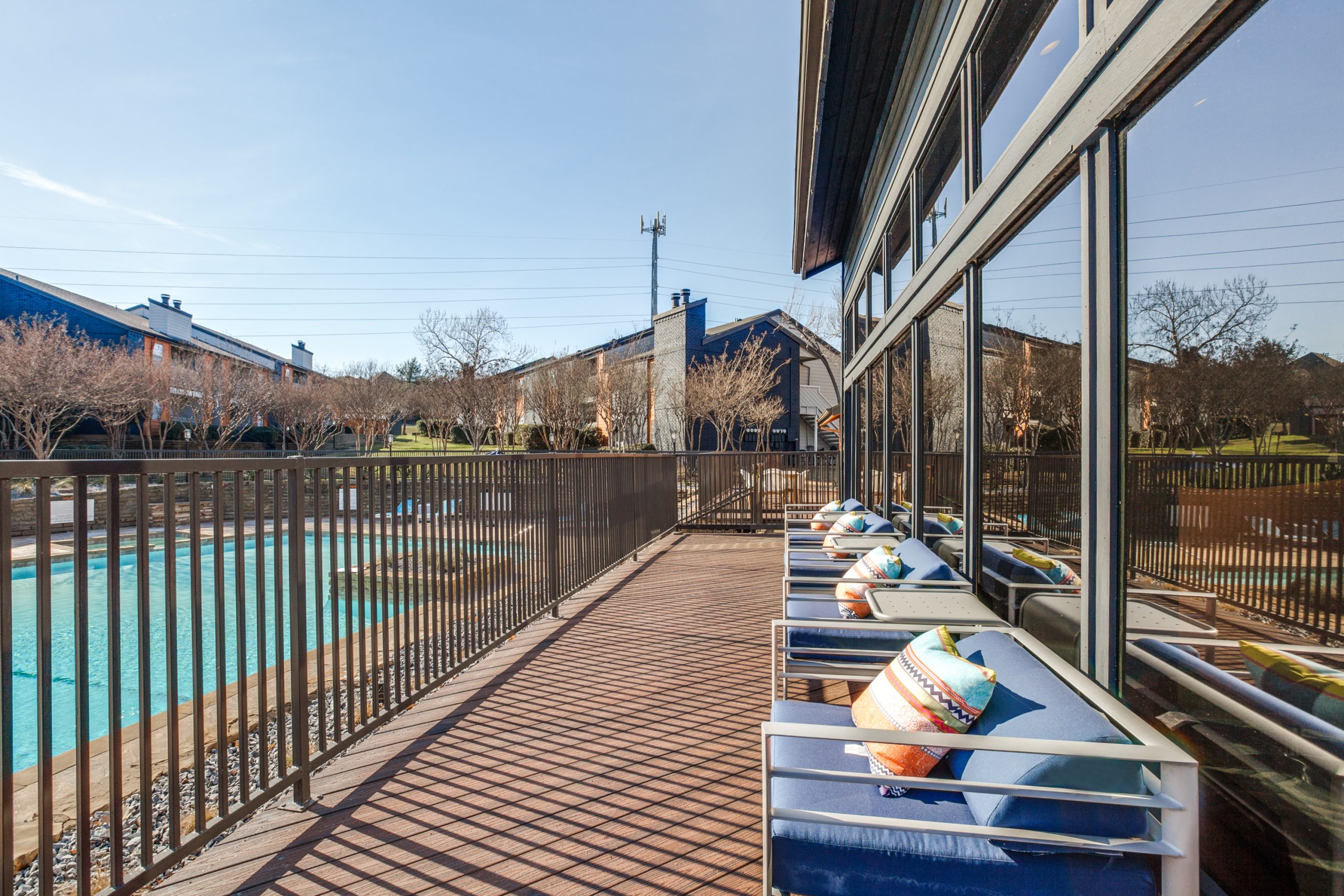 a deck with chairs and a pool in the background at The Preslee